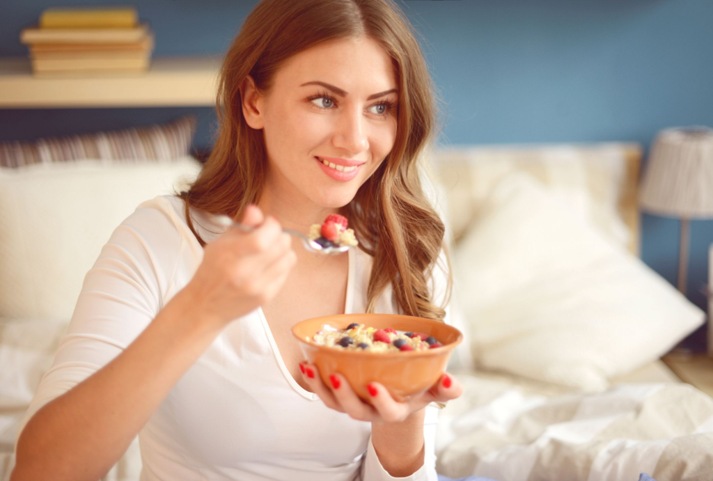 women eating healthy food while sitting on bed