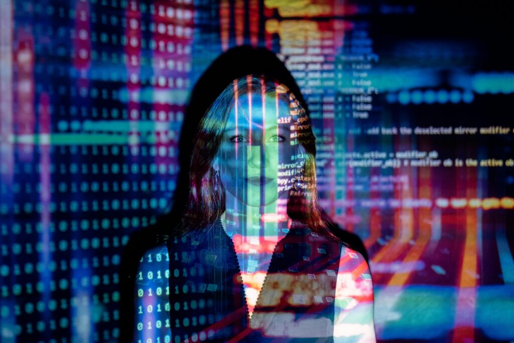 A woman with digital code projections on her face, representing AI Coaching technology and future concepts.