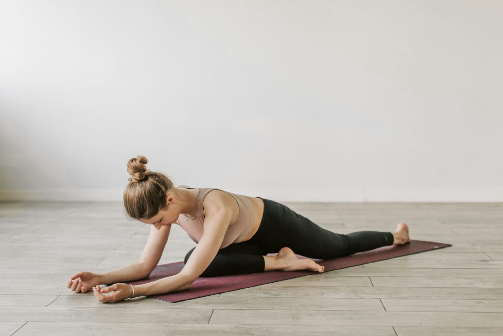 Woman in yoga pose on mat, promoting fitness and wellness indoors.