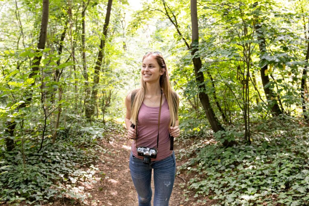 young woman doing nature walks and smiling