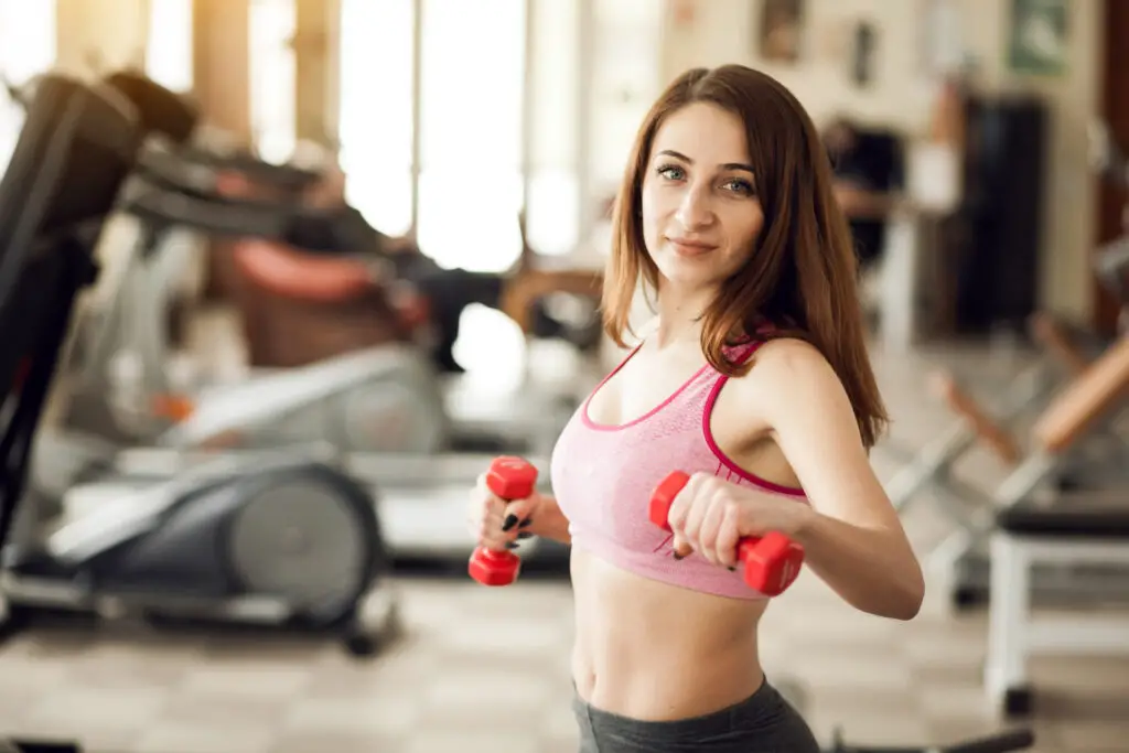 This image shows the woman doing light weightlifting.