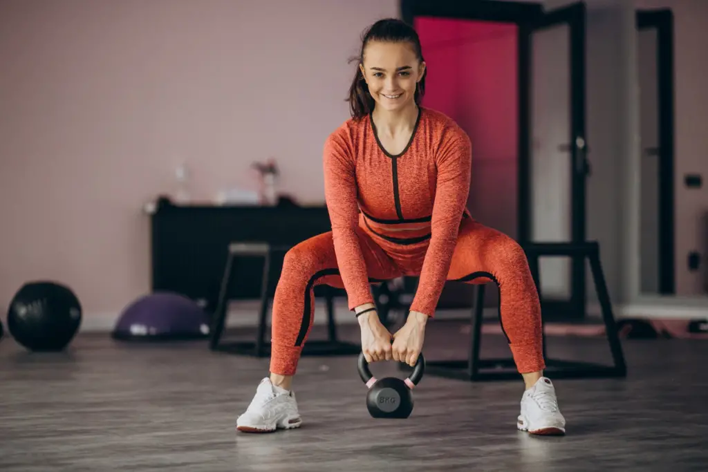 This image shows the young girl doing weightlifting.