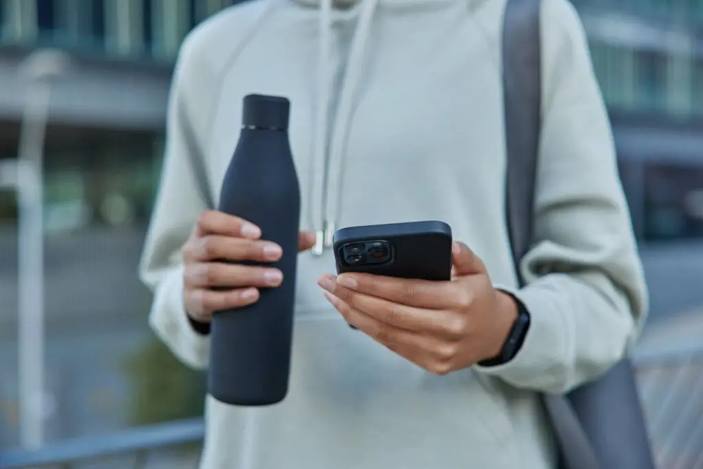 Person holding the AI-powered smart bottles with iPhone