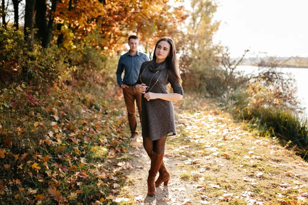 This image shows the young man and woman walking in the nature.