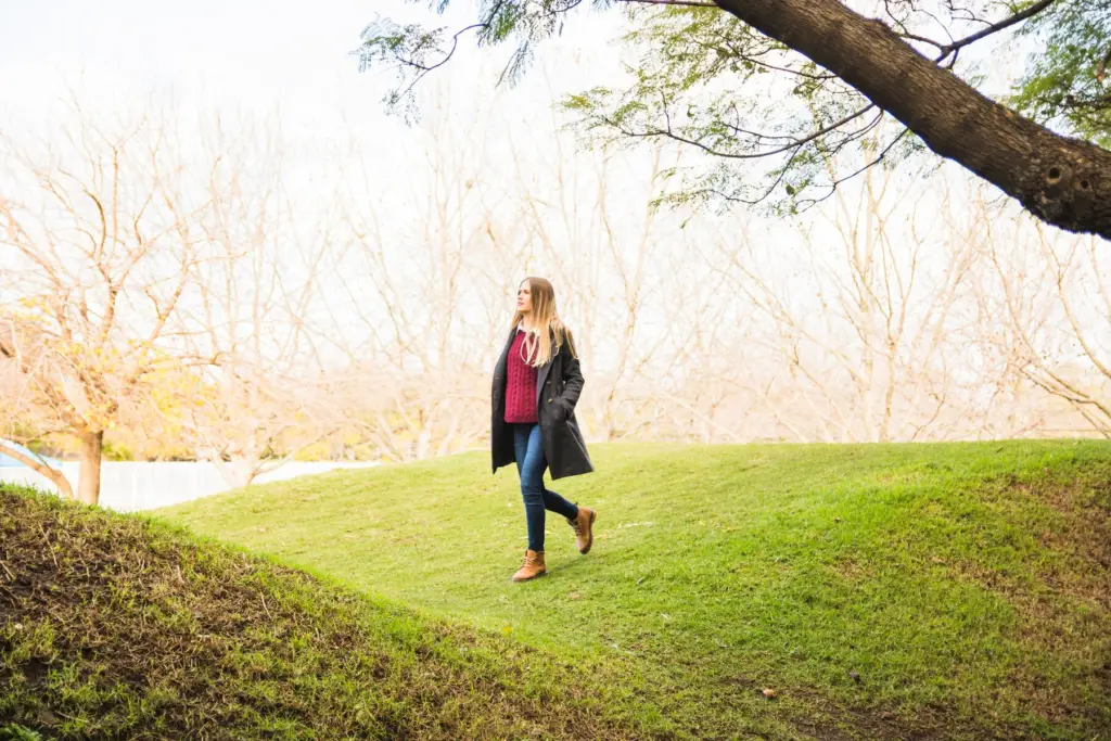 Woman walking in nature to reduce anxiety.