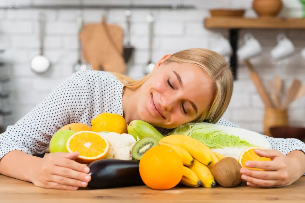 Medium shot smiley girl hugging fresh healthy fruits and improving her overall well-being.